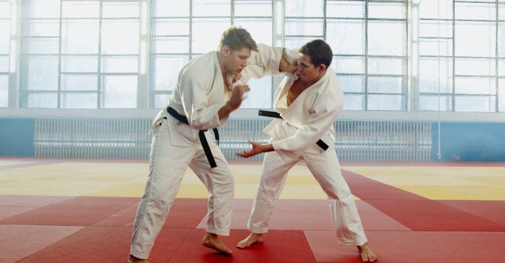 Two adults practicing partner defense drills in martial arts for adults.