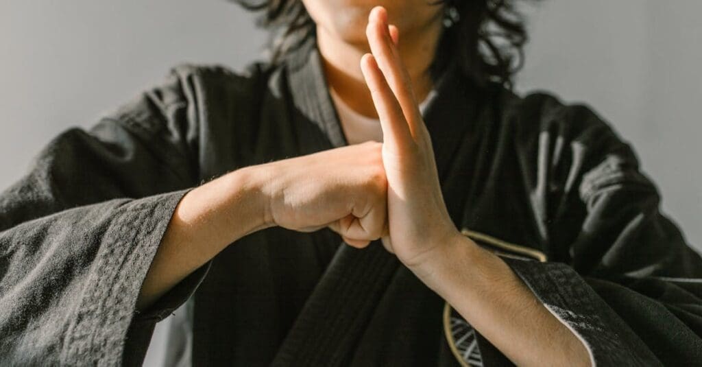 Adult beginner martial arts practicing controlled hand technique for safety.