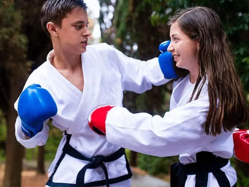 Teen partners practicing sparring drills to build martial arts confidence for teens