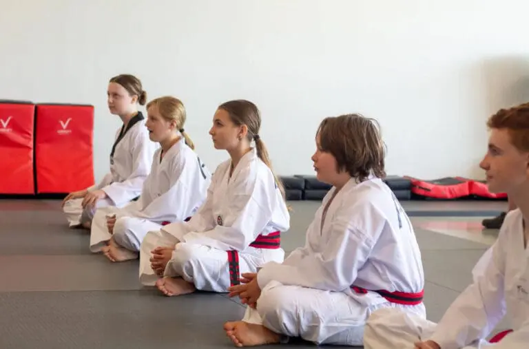 Teen students listening during class to build teen martial arts discipline