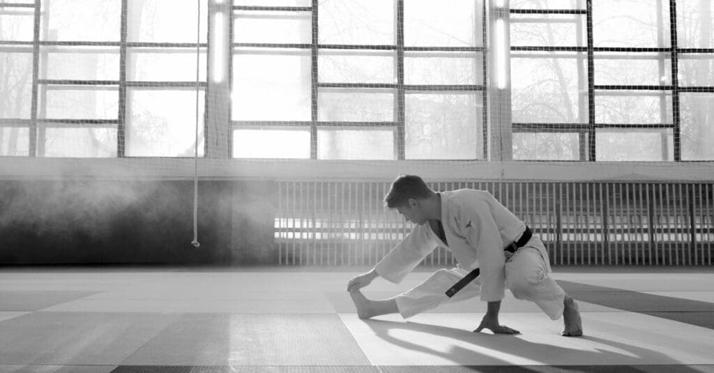 Martial arts student stretching before class for taekwondo training for teen development