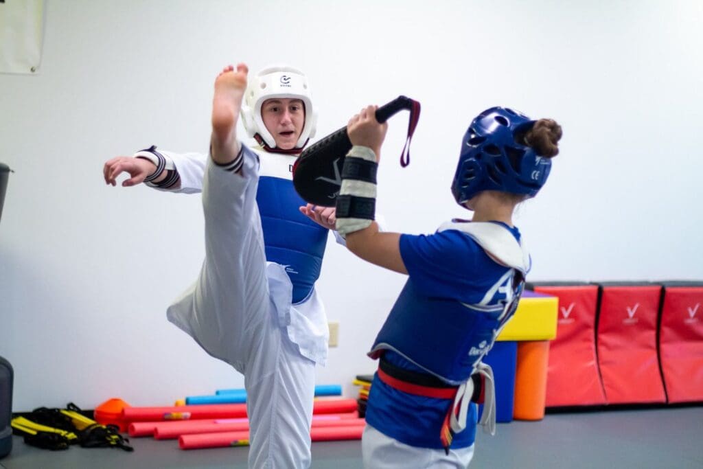 teen practicing high kicks for teens taekwondo lesson